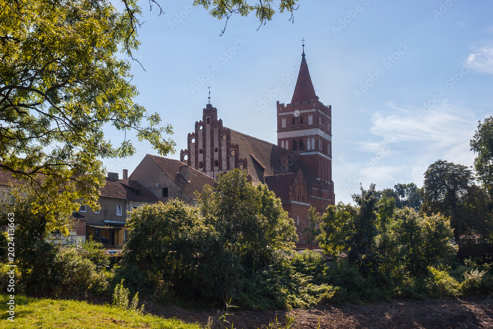 Naklejka premium View of the Church of St. Great Martyr George the Victorious in Pravdinsk (prior Friedland), Kaliningrad Oblast, Russia. The original stone building was erected 1360-1380, rebuilt in the 15th century.