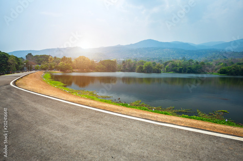 Along road landscape view in Ang Kaew Chiang Mai University Forested Mountain blue sky background with white clouds, Nature Road in mountain forest. photo