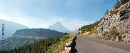 CLEMENT MOUNTAIN AT THE TOP OF LOGAN PASS UNDER CIRRUS CLOUDS DURING THE 2017 FALL FIRES IN GLACIER NATIONAL PARK IN MONTANA UNITED STATES photo