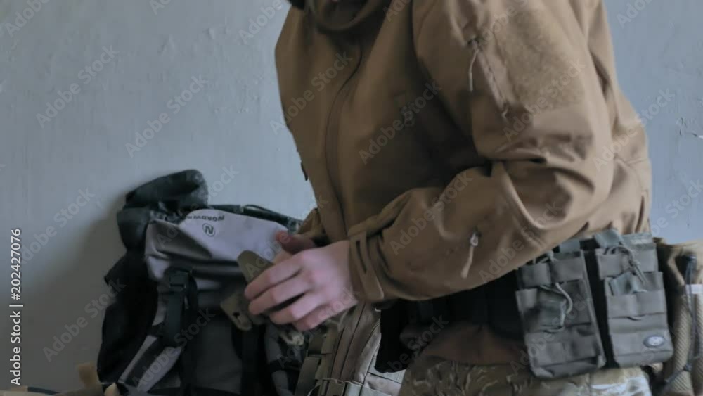 Soldiers in camouflage prepare for battle and check out equipment and weapons Soldiers in camouflage prepare for battle and check out equipment and weapons