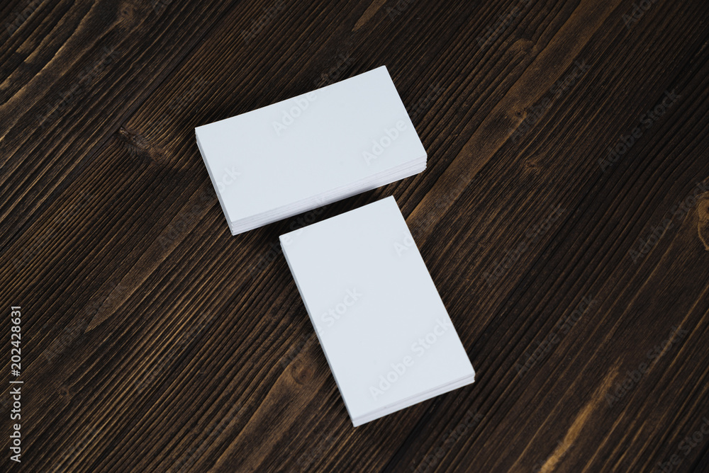 Blank business cards on wooden working table with copy space for add text ID. and logo, business company concept. Blank business cards on wooden working table with copy space for add text ID. and logo, business company concept.
