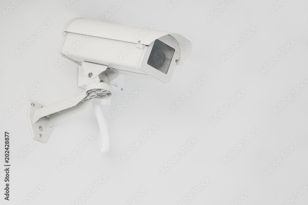 CCTV security camera installed on the building wall, operating indoor and outdoor, surveillance system. CCTV security camera installed on the building wall, operating indoor and outdoor, surveillance system.