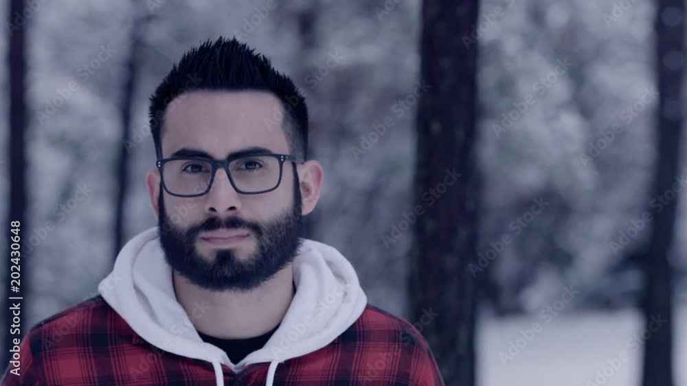Attractive man looking meaningfully into camera in falling snow. Attractive man looking meaningfully into camera in falling snow.