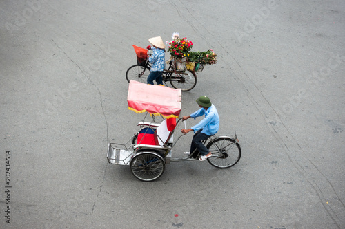 Cyclo or pedicab driver on Hanoi street photo