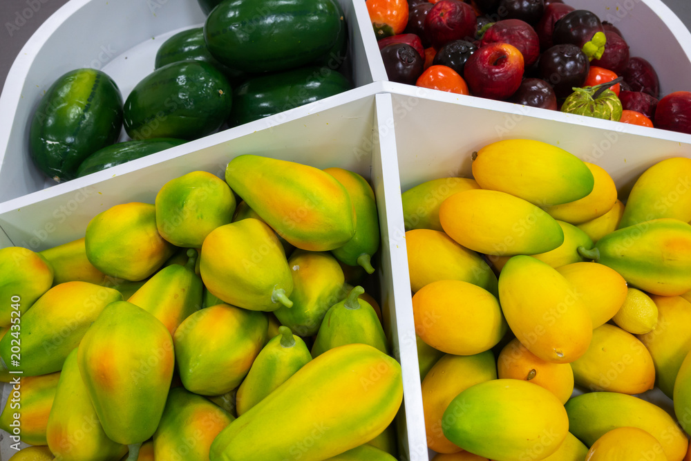 Plastic fruits on model supermarket shelf. Children pay toys Plastic fruits on model supermarket shelf. Children pay toys