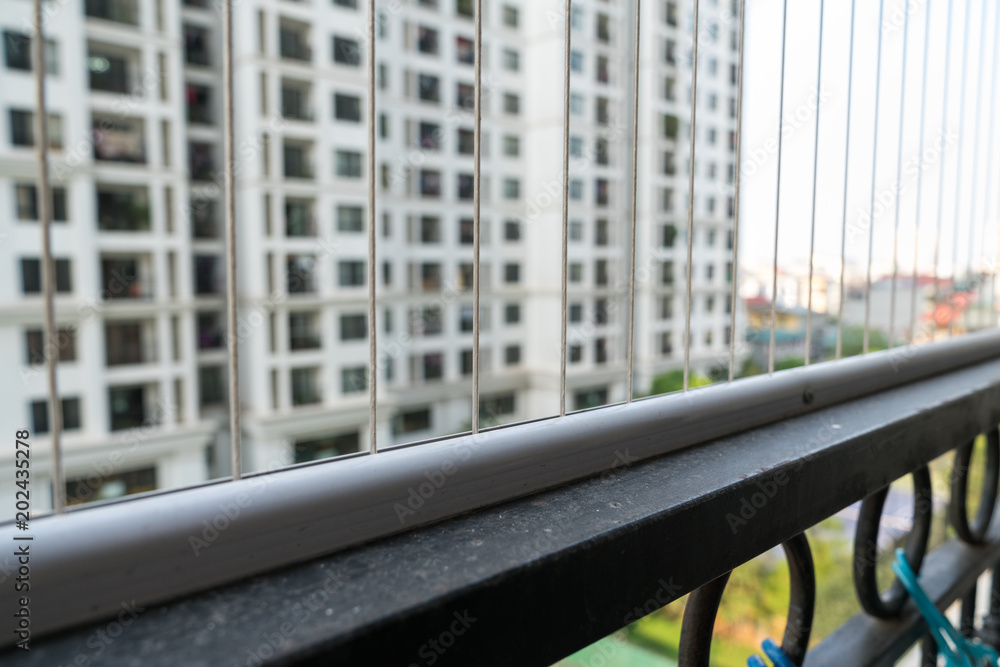Protection wire fence on opened area on window in apartment building. Prevention of children climbing out Protection wire fence on opened area on window in apartment building. Prevention of children climbing out