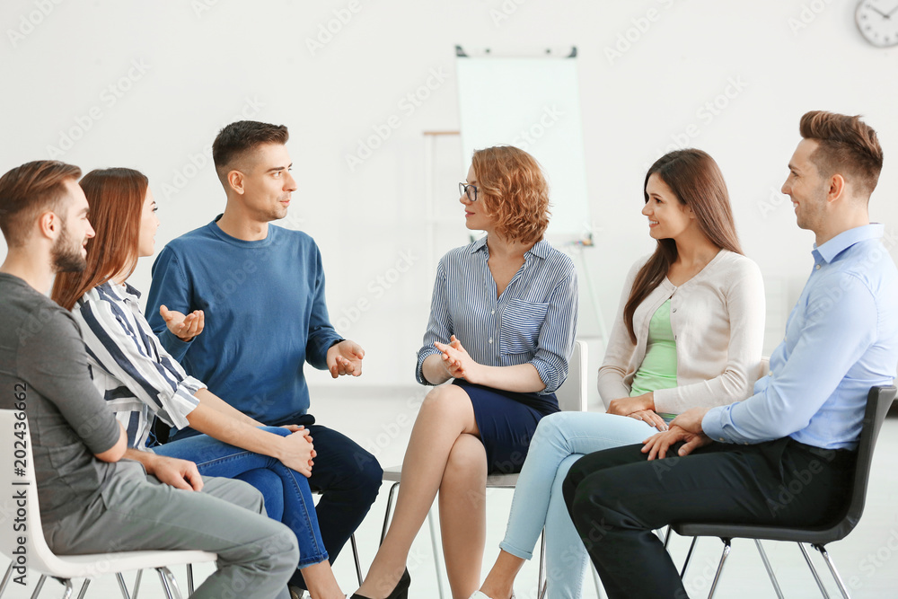 People at group psychotherapy session indoors People at group psychotherapy session indoors