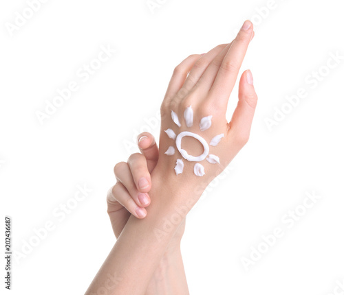 Young woman applying hand cream against on white background