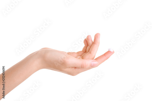 Young woman applying hand cream against on white background