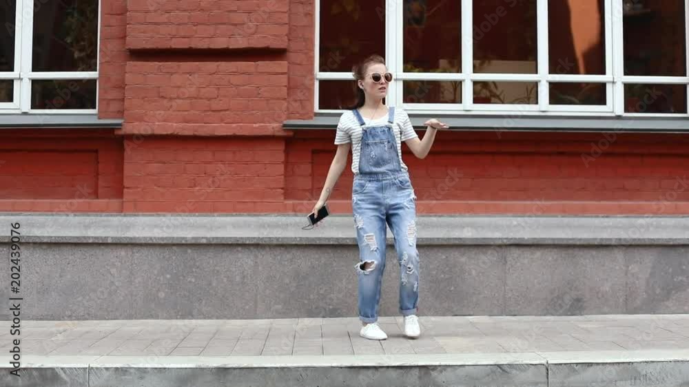 Happy girl dancing on the street Happy girl dancing on the street