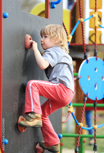 Child on climbing-wall in playground
