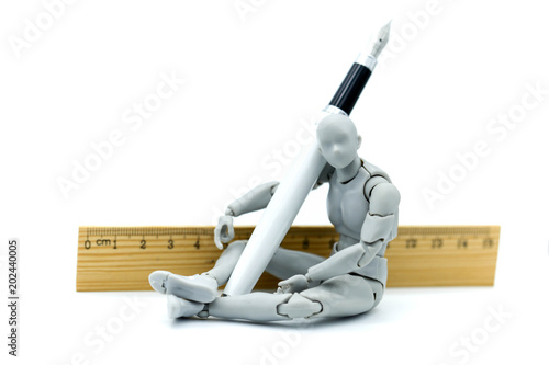 Model robot with pen and ruler.