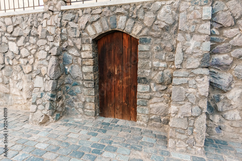 Ancient wooden door in the wall, brown. Texture © Aliaksandr Marko