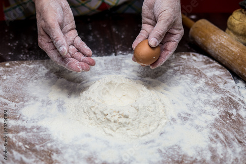 Female hands making dough for pizza. Making bread. Cooking Process Concept