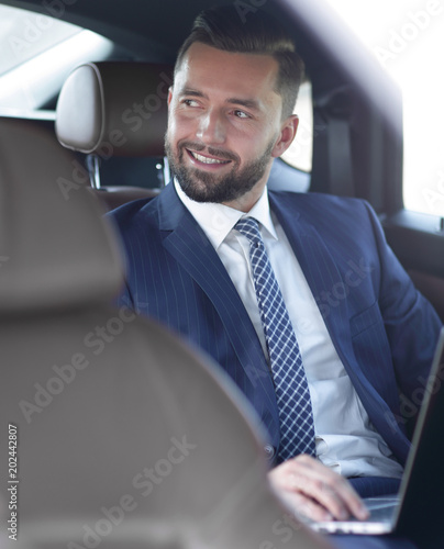 Close-up of a successful businessman sitting in a car © ASDF