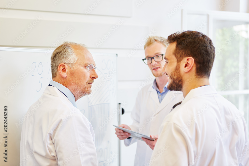 Chefarzt und Assistenzärzte in Besprechung Chefarzt und Assistenzärzte in Besprechung