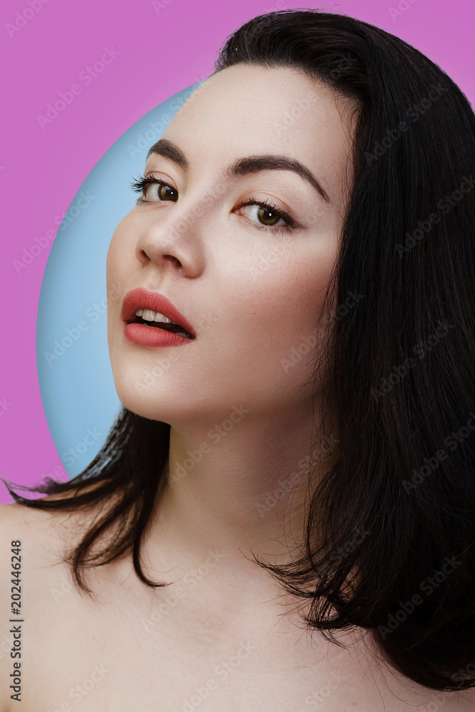 Obraz premium Young sexy lady with clean skin red lips and black straight hairstyle. Mixed race Caucasian Asian female model