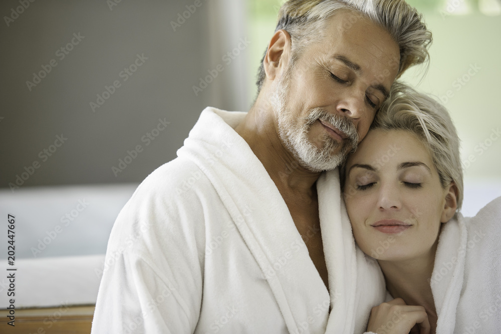Couple in bathrobes embracing Couple in bathrobes embracing