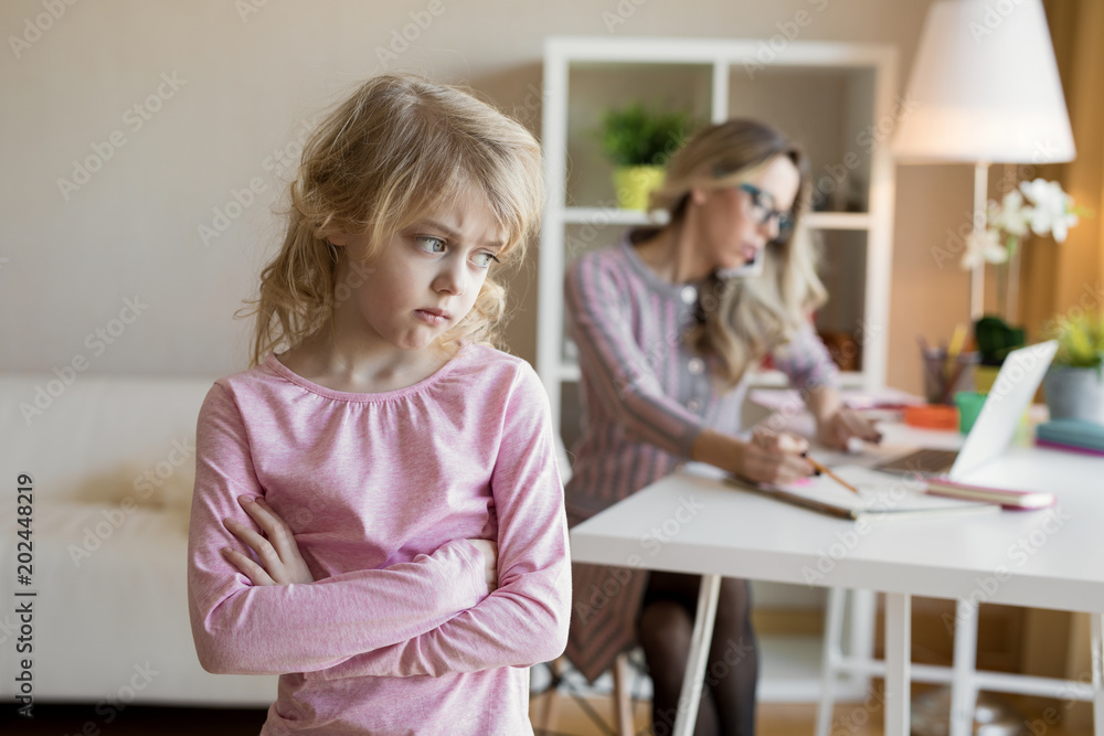 Businesswoman busy working while her child is left without attention Businesswoman busy working while her child is left without attention