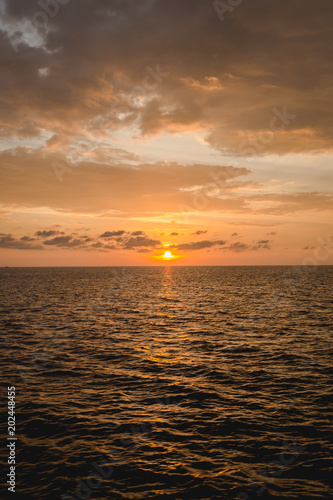 Fototapeta Naklejka Na Ścianę i Meble -  dark drop of sunset from sky on the ocean in evening time