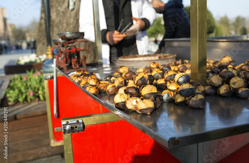 Grilled chestnuts for sale in market stall