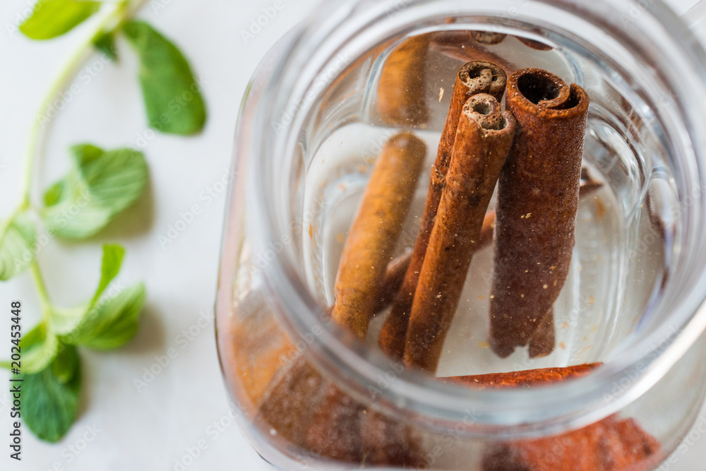Water with Cinnamon Sticks in Mason Jar. Water with Cinnamon Sticks in Mason Jar.