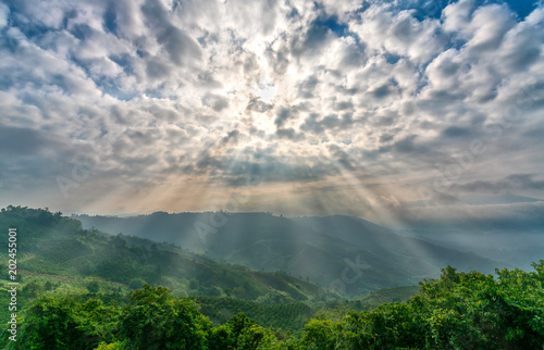 Ta Dung lake in the morning when sun rays at the top of the mountain shines fog into the lake full of mist and small islands paradise. This is the reservoir for hydropower in Dac Nong  Vietnam.