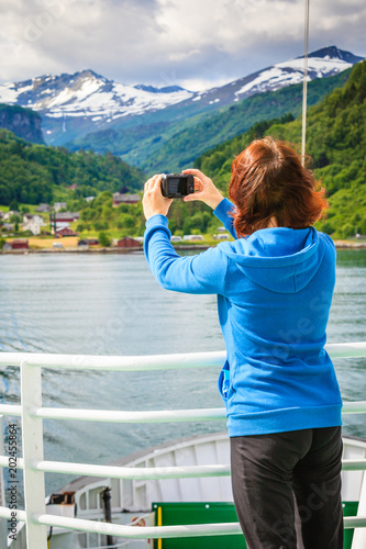 Tourist woman on liner taking photo, Norway photo