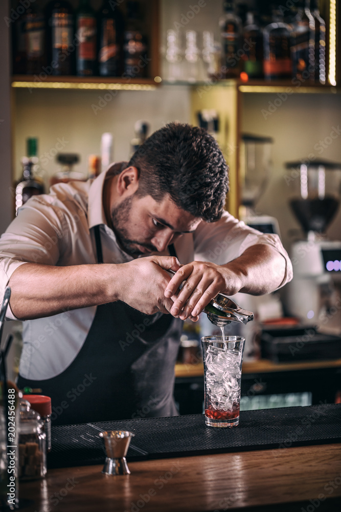 Professional bartender making cocktail
