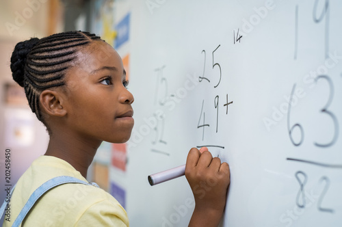 Fotografie, Obraz Girl solving mathematical addition