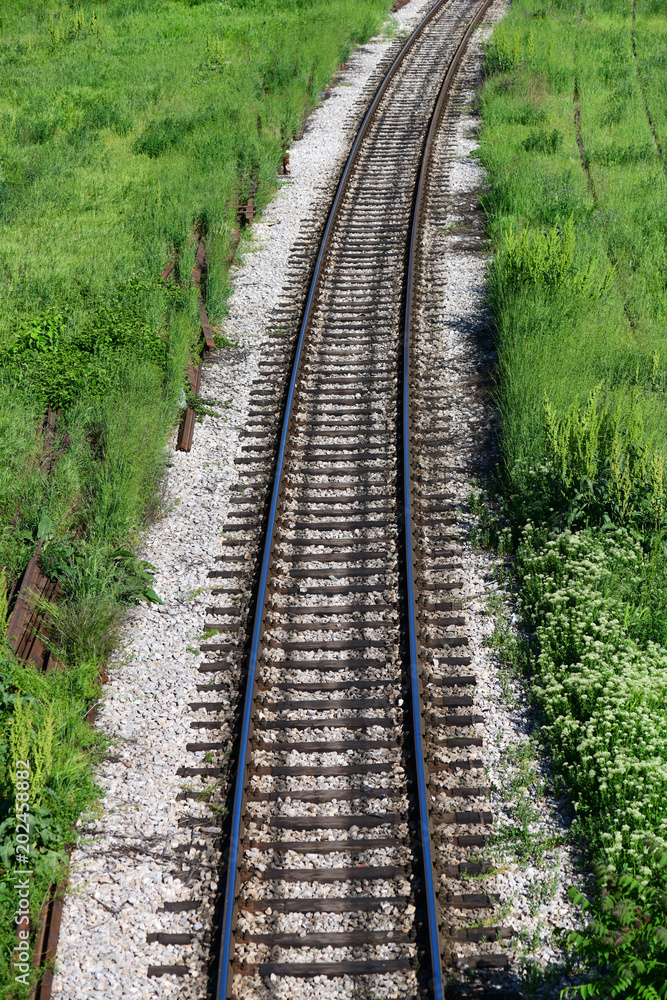 Railroad and green grass. Train rails Railroad and green grass. Train rails
