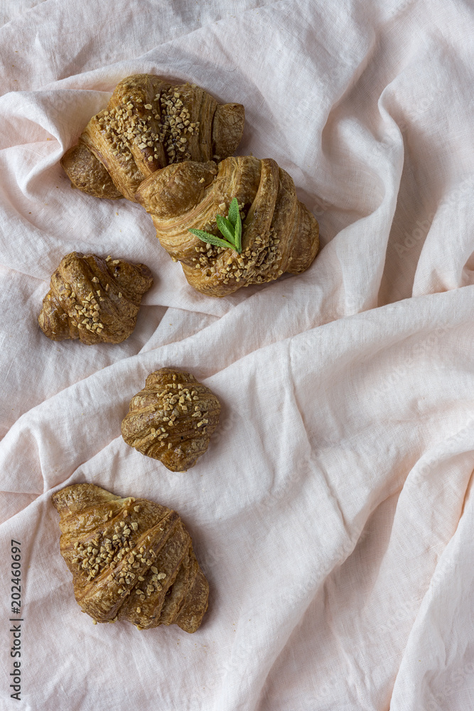 Delicious baked croissants on fabric Delicious baked croissants on fabric