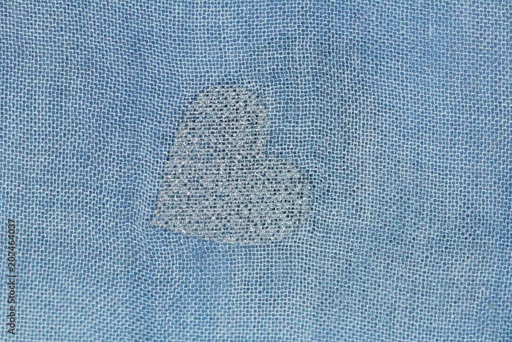 Silver heart on a blue background of cotton fabric. Romantic pastel  background. Design with copy space. Denim color Stock Photo | Adobe Stock