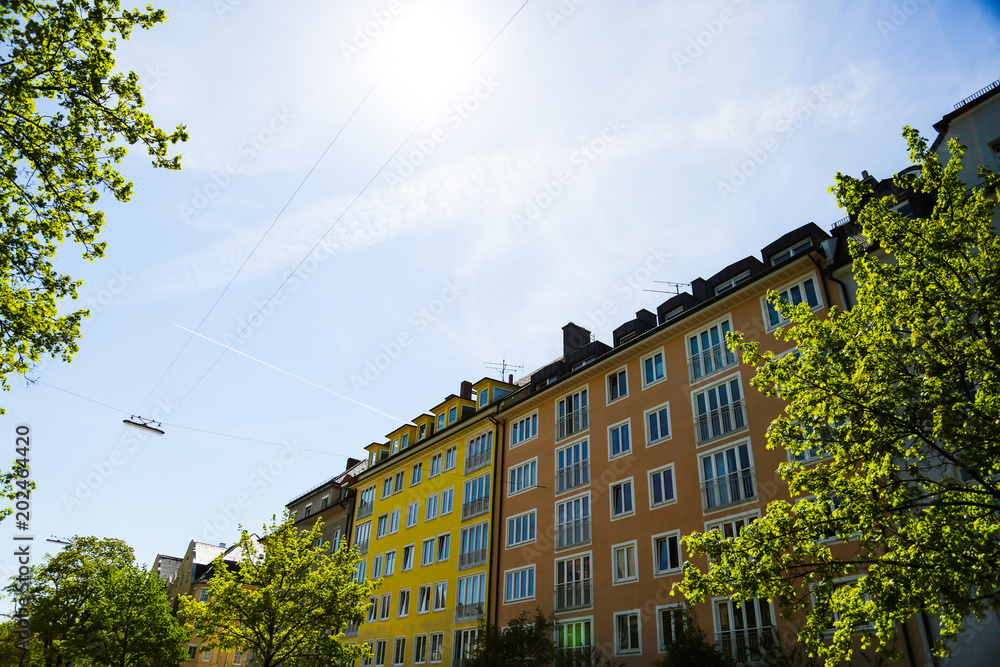 Residential houses, row of houses in Munich, beautiful residential area, blue sky