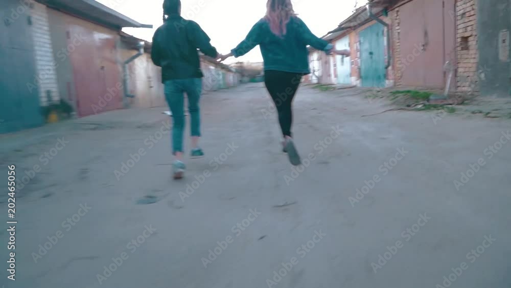 two girls running around the garage. shake camera effect two girls running around the garage. shake camera effect