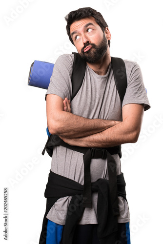 Handsome backpacker making unimportant gesture on white background