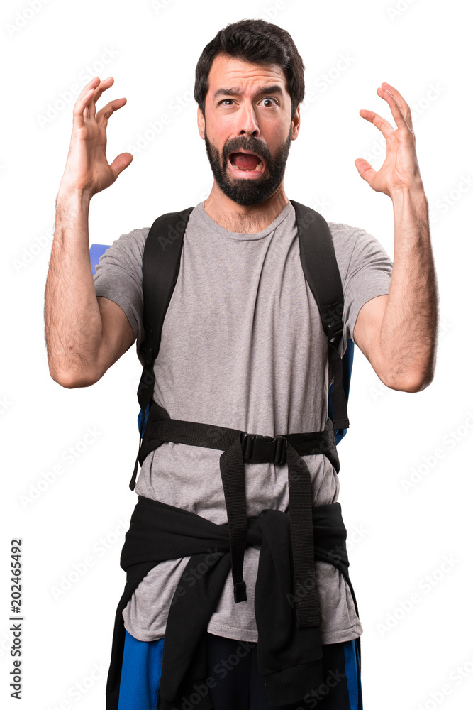 Fototapeta premium Frustrated handsome backpacker on white background