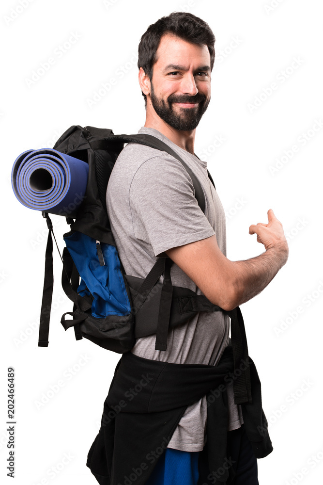 Handsome backpacker pointing back on white background Handsome backpacker pointing back on white background
