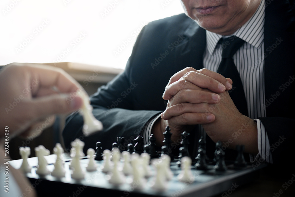 Confident businessman colleagues playing chess game overcome the fear of confrontation to development analysis new strategy plan, leader and teamwork concept for success Confident businessman colleagues playing chess game overcome the fear of confrontation to development analysis new strategy plan, leader and teamwork concept for success
