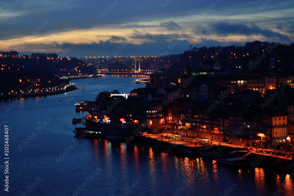 View of Douro river and Ribeira at night time, Porto, Portugal.