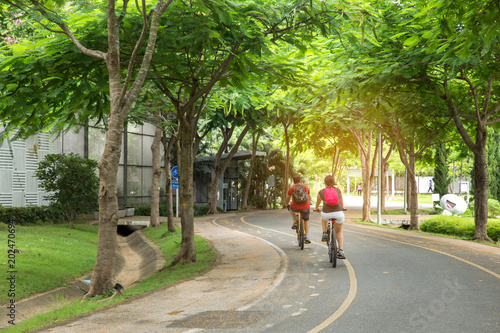 couple ride bicycles in the morning at public park © Pcess609