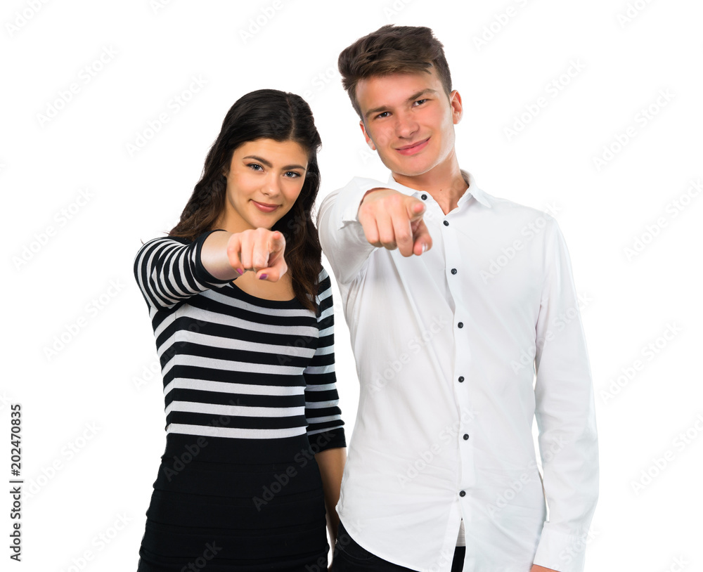 Young couple points finger at you on isolated white background Young couple points finger at you on isolated white background