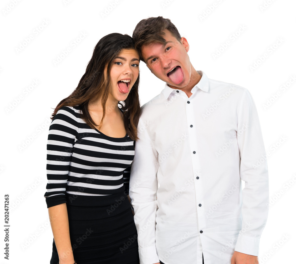Young couple showing tongue at the camera having funny look on isolated white background Young couple showing tongue at the camera having funny look on isolated white background