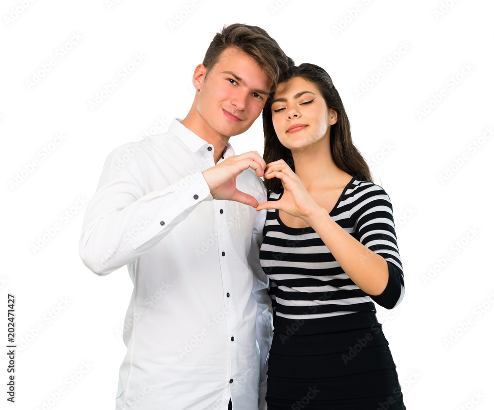 Young teenager couple making a heart with hands on isolated white background Young teenager couple making a heart with hands on isolated white background