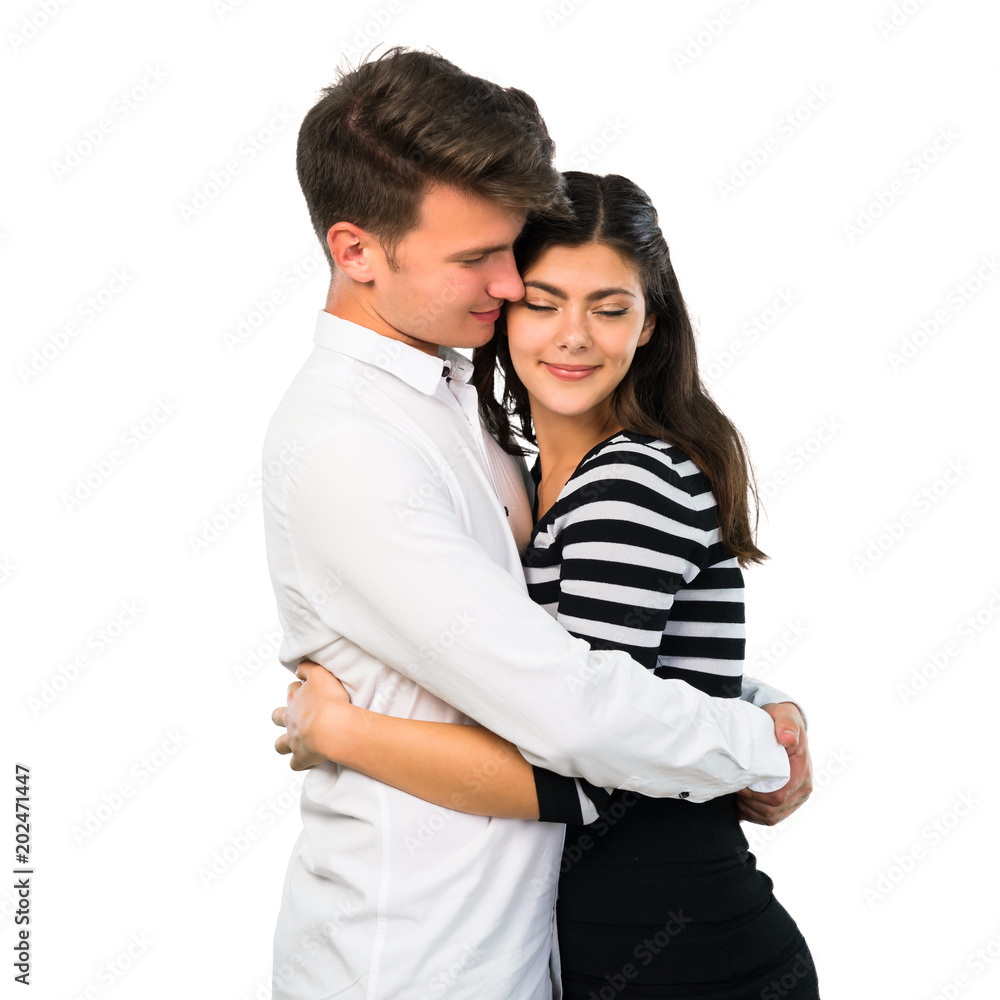 Young teenager couple hugging on isolated white background Young teenager couple hugging on isolated white background