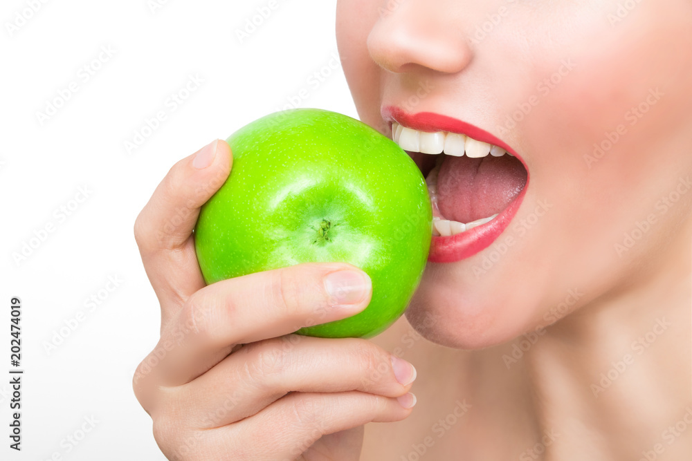 Woman bites in green apple Woman bites in green apple