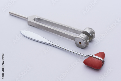  Reflex hammer and tuning forks on white background photo