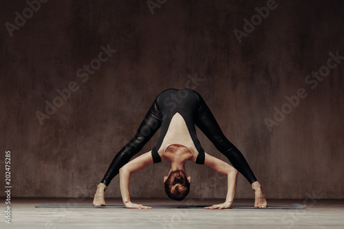 Young beautiful athlete is posing in studio