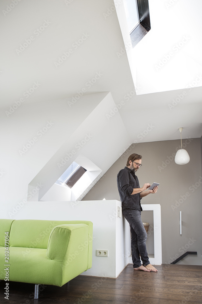 Businessman using tablet at home Businessman using tablet at home
