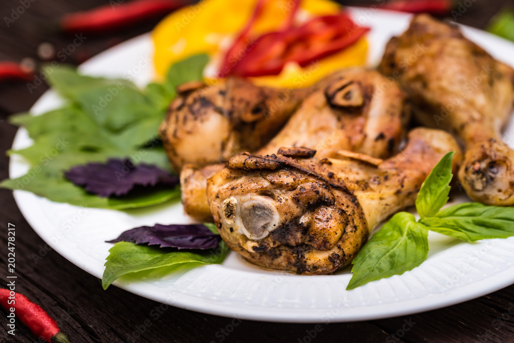 Roasted chicken quarter legs on rustic background Roasted chicken quarter legs on rustic background